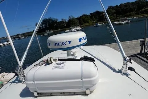  Yacht Photos Pics 2017 Regulator 31 boat with radar and life raft, docked in a scenic marina.