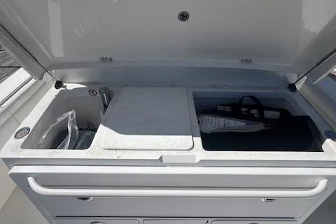  Yacht Photos Pics 2017 Regulator 31 boat storage compartment with open lid and organized interior.