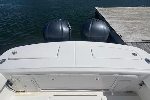  Yacht Photos Pics 2017 Regulator 31 boat with dual outboard motors docked by wooden pier.