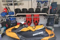 Jet ski in storage with gear, featuring a 2004 Custom Line model 94.