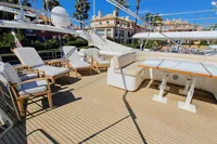 Luxurious yacht deck with seating and dining area, Custom Line 94, 2004 model.