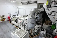Engine room of a 2004 Custom Line 94 yacht, featuring machinery and ventilation systems.