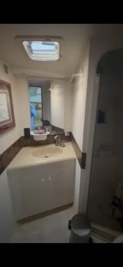  Yacht Photos Pics Bathroom interior of a 1998 Viking 43 Convertible yacht, featuring a sink and mirror.