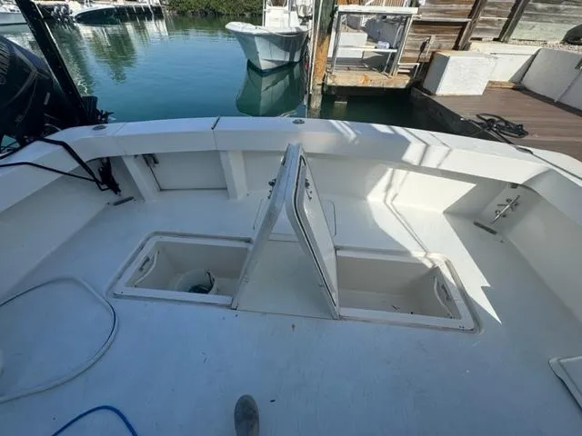  Yacht Photos Pics 1998 Viking 43 Convertible boat deck with open storage compartments at marina.