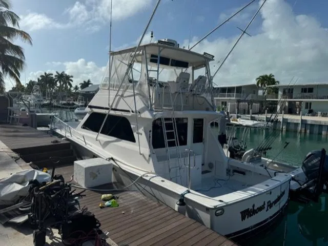  Yacht Photos Pics 1998 Viking 43 Convertible yacht docked at marina under clear sky.