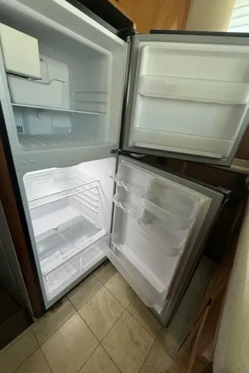 Yacht Photos Pics Open refrigerator in a 1998 Viking 43 Convertible, showing empty shelves and compartments.