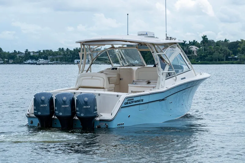  Yacht Photos Pics 2017 Grady-White Freedom 335 boat with triple Yamaha engines on a calm lake.