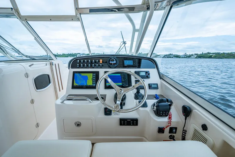  Yacht Photos Pics 2017 Grady-White Freedom 335 boat helm with navigation screens and controls on open water.