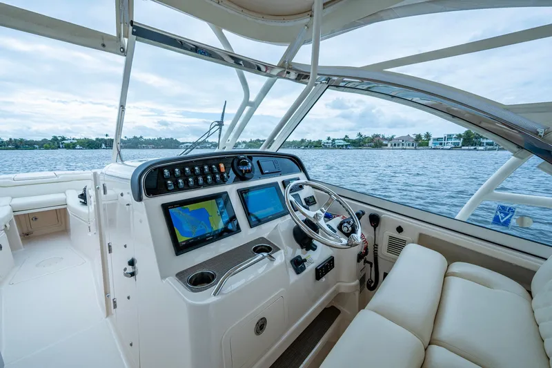  Yacht Photos Pics 2017 Grady-White Freedom 335 boat interior with navigation system and steering wheel.