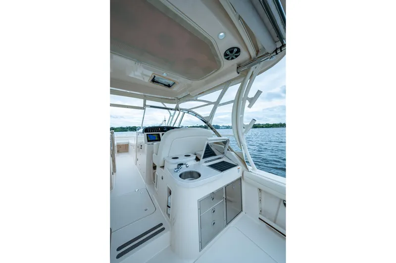  Yacht Photos Pics 2017 Grady-White Freedom 335 boat interior with helm, seating, and water view.