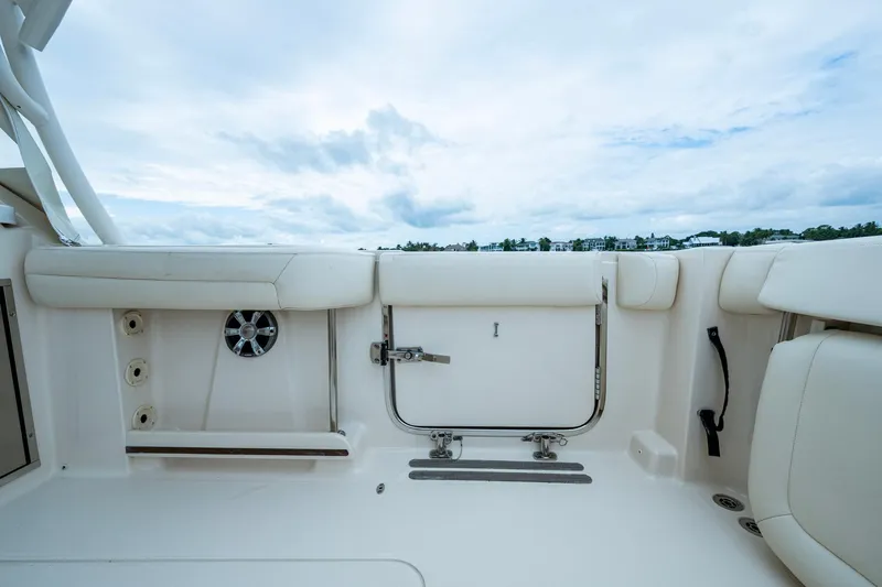  Yacht Photos Pics 2017 Grady-White Freedom 335 boat interior with white seating and storage compartments.