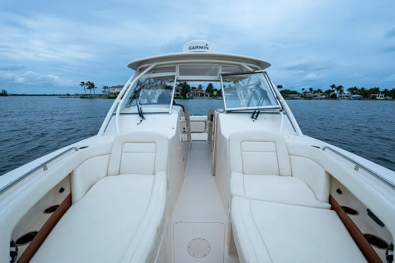  Yacht Photos Pics 2017 Grady-White Freedom 335 boat interior with white seating on a calm water backdrop.