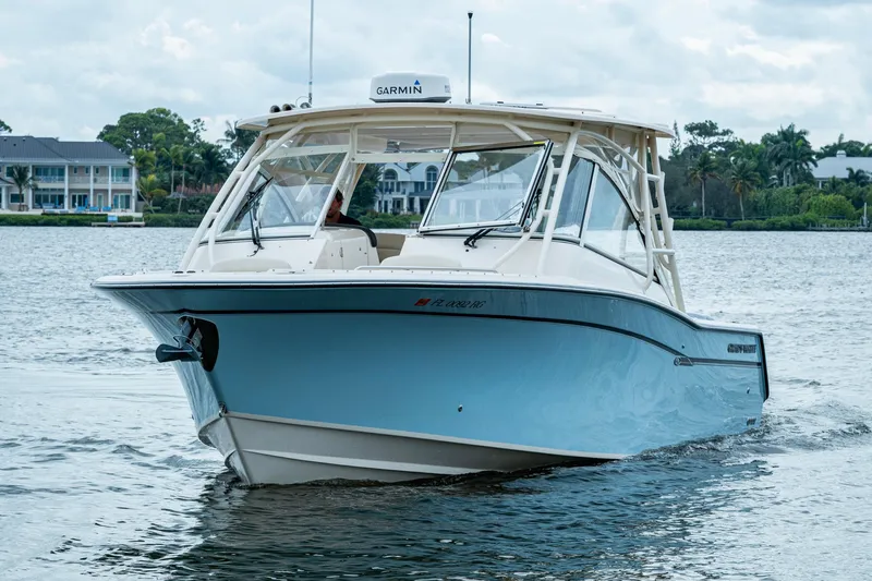  Yacht Photos Pics 2017 Grady-White Freedom 335 boat cruising on a calm waterway.