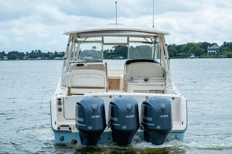  Yacht Photos Pics 2017 Grady-White Freedom 335 boat with triple Yamaha 300 engines on a calm lake.