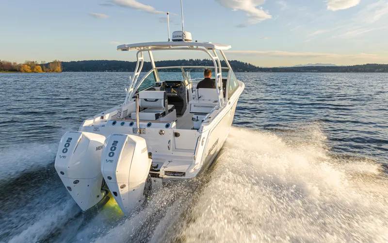  Yacht Photos Pics 2024 Blackfin 252 DC boat cruising on a lake at sunset.