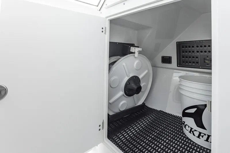  Yacht Photos Pics 2024 Blackfin 252 DC storage compartment with equipment and Blackfin-branded bucket.
