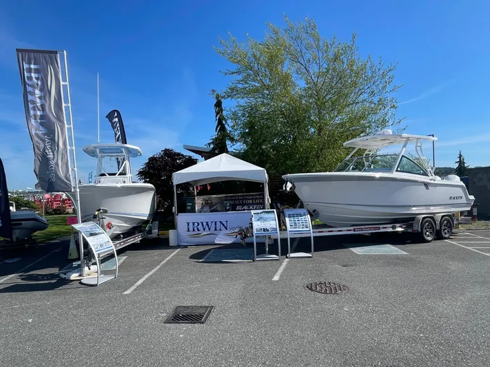  Yacht Photos Pics 2024 Blackfin 252 DC boats displayed outdoors at a boat show with promotional banners.