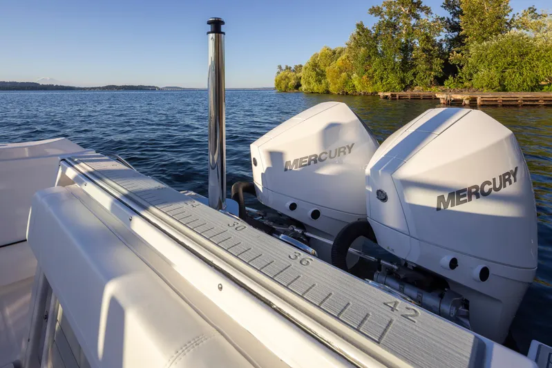  Yacht Photos Pics 2024 Blackfin 252 DC boat with dual Mercury engines on a serene lake.