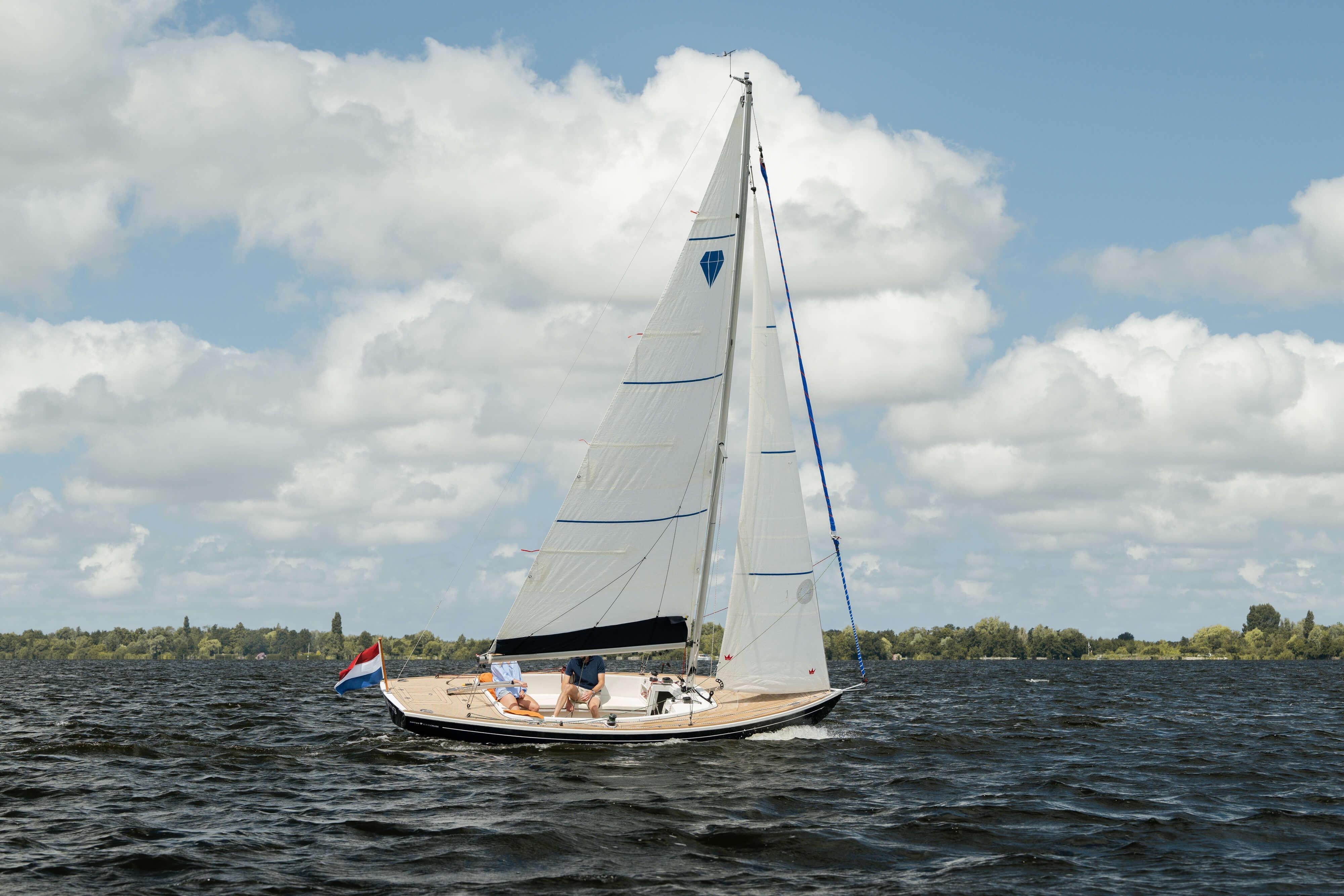 2026 Saffier SC 6.5 Cruise sailing on a lake under a cloudy sky.