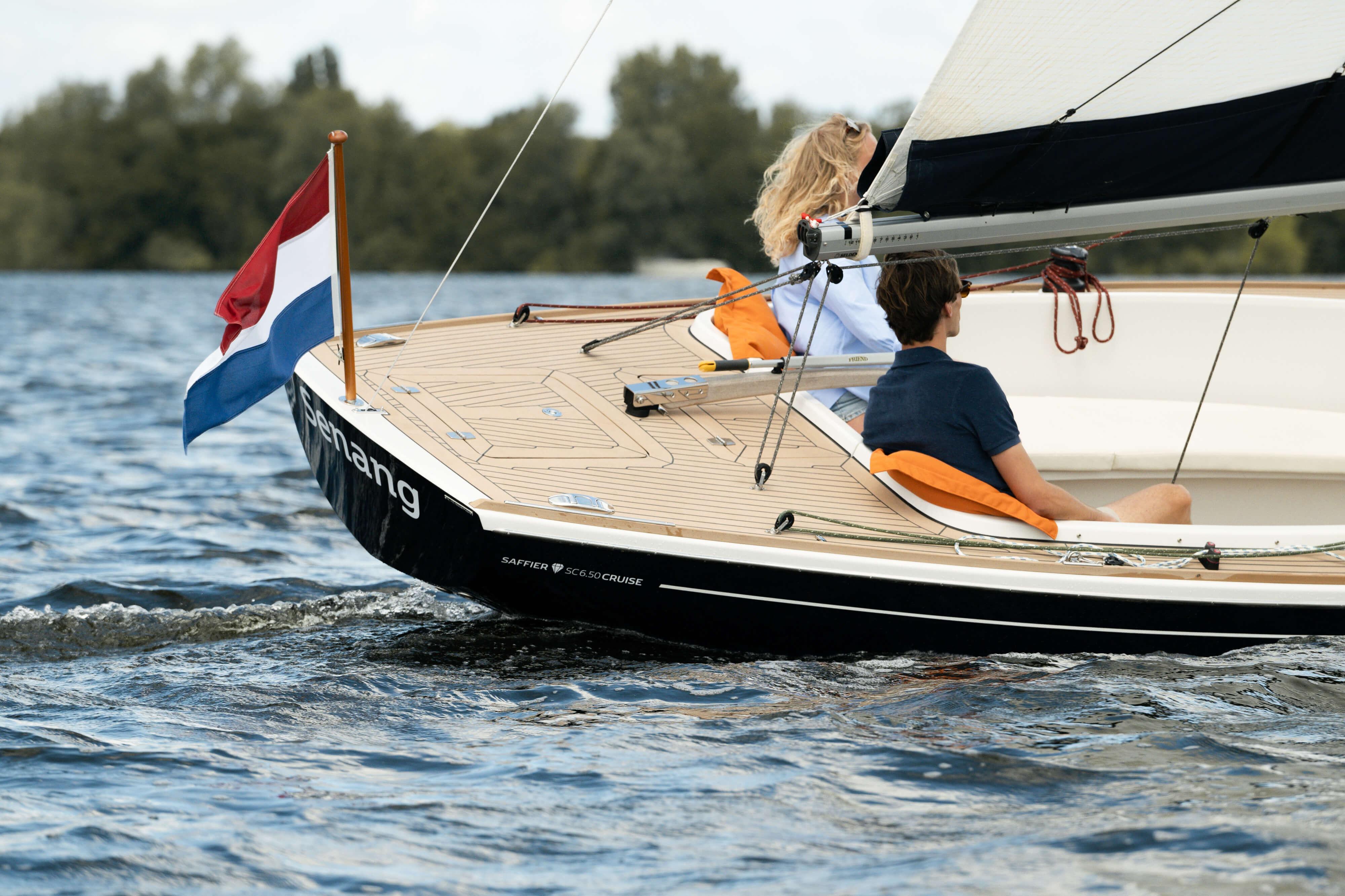 2026 Saffier SC 6.5 Cruise sailing on a lake with two passengers onboard.