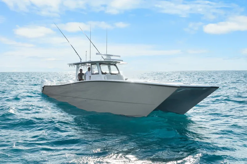  Yacht Photos Pics Futuristic Freeman 47 boat cruising on open ocean, clear skies above.