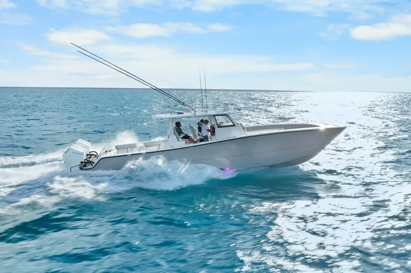  Yacht Photos Pics Freeman 47 boat cruising on open sea, 2099 model, under clear blue sky.