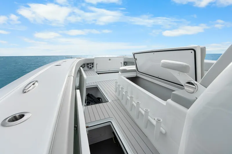  Yacht Photos Pics Freeman 47 boat deck with open storage, rod holders, and ocean view, year 2099.