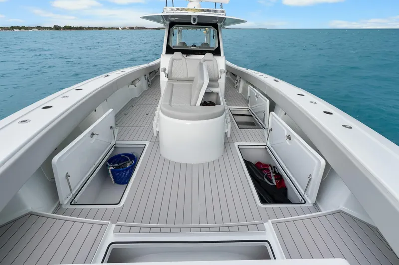  Yacht Photos Pics Modern Freeman 47 boat deck with open storage compartments, cruising on a clear blue sea, year 2099.