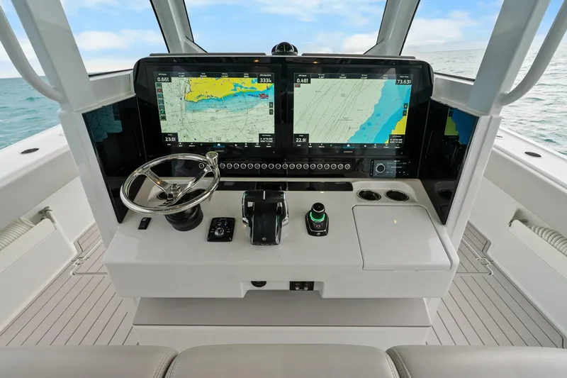 Yacht Photos Pics Futuristic Freeman 47 boat dashboard with advanced navigation screens, steering wheel, and controls.