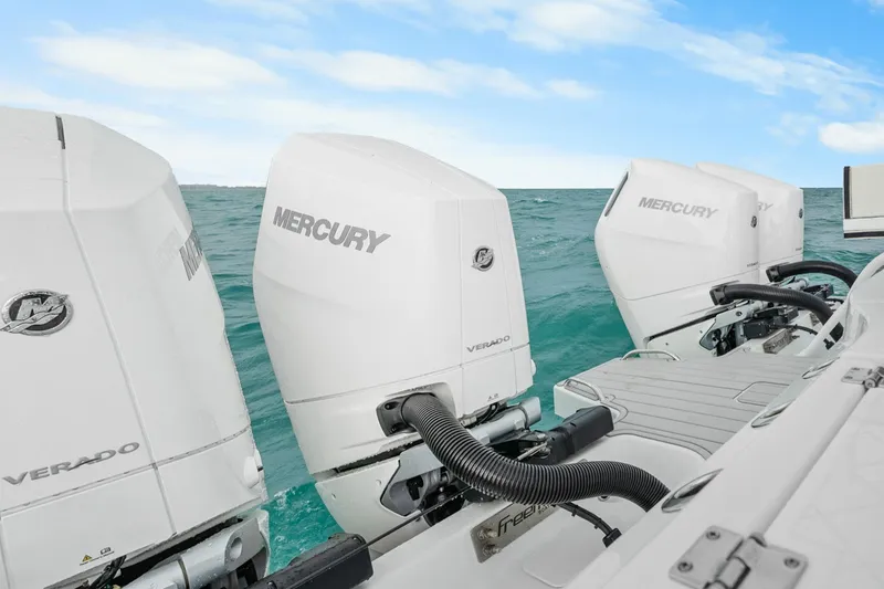  Yacht Photos Pics Four Mercury Verado outboard engines on a Freeman 47 boat, ocean backdrop, 2099 model.