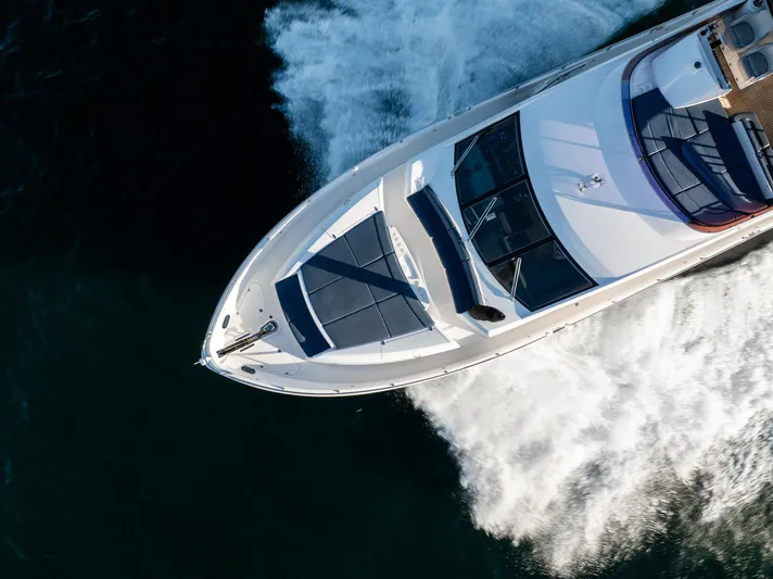 Just For Fun Yacht Photos Pics Aerial view of 2011 Sunseeker Manhattan 73 yacht cruising on water.