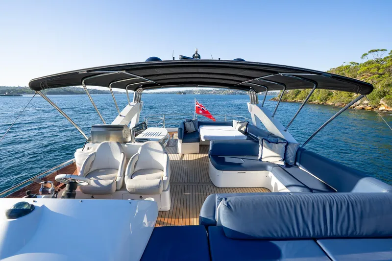 Just For Fun Yacht Photos Pics Luxurious Sunseeker Manhattan 73 yacht deck with seating, ocean view, and canopy, 2011 model.