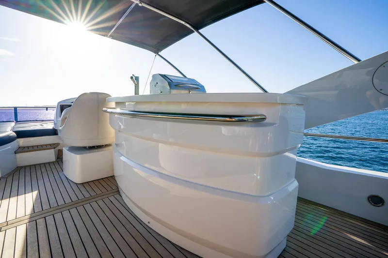 Just For Fun Yacht Photos Pics Luxurious Sunseeker Manhattan 73 yacht deck with sleek design, 2011 model, under sunny skies.