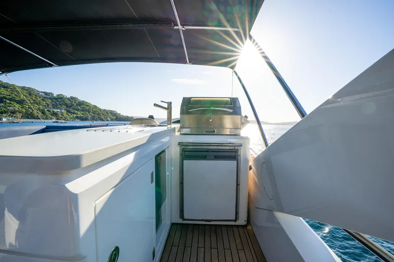 Just For Fun Yacht Photos Pics Sunseeker Manhattan 73 yacht deck with grill, ocean view, and sunlight, 2011 model.