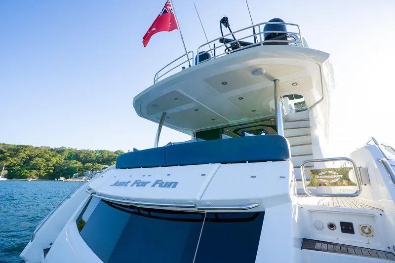 Just For Fun Yacht Photos Pics Sunseeker Manhattan 73 yacht, 2011 model, docked with a red flag, sunny day.
