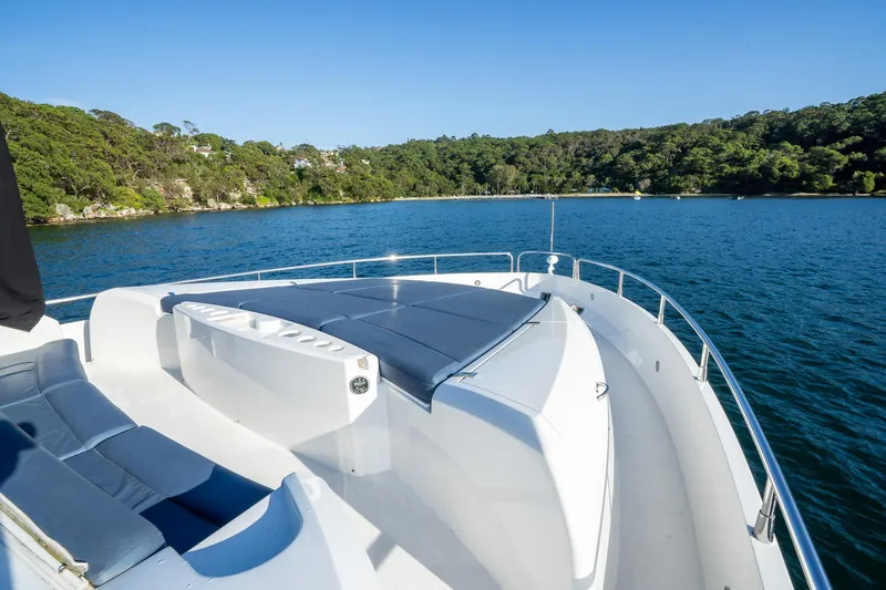 Just For Fun Yacht Photos Pics Luxurious Sunseeker Manhattan 73 yacht deck, 2011 model, overlooking serene waters and lush greenery.