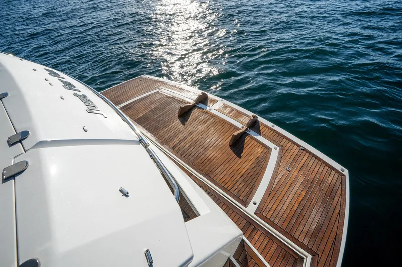 Just For Fun Yacht Photos Pics Sunseeker Manhattan 73 yacht, 2011 model, with wooden deck on calm water.