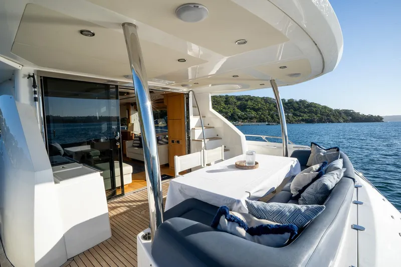 Just For Fun Yacht Photos Pics Luxurious Sunseeker Manhattan 73 yacht deck with seating, table, and ocean view.