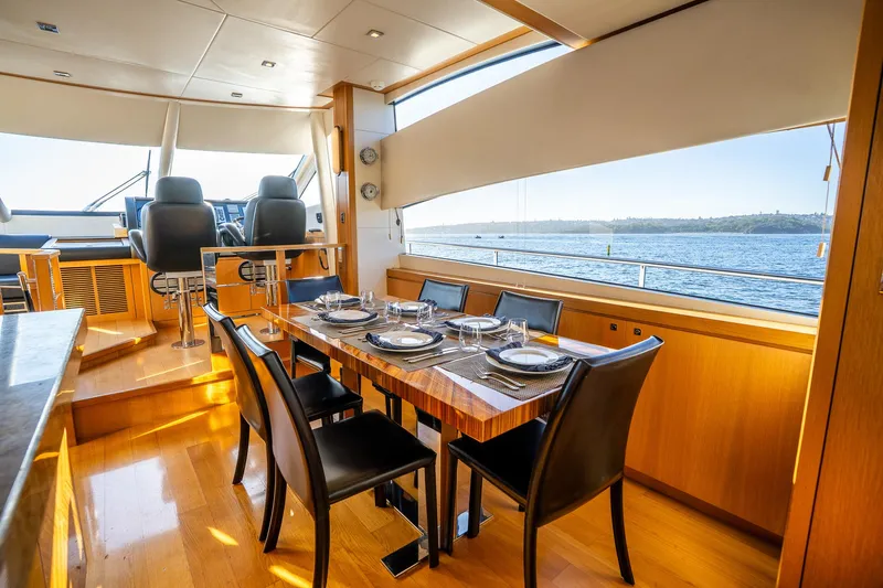 Just For Fun Yacht Photos Pics Luxurious interior of 2011 Sunseeker Manhattan 73 yacht with elegant dining area and scenic ocean view.