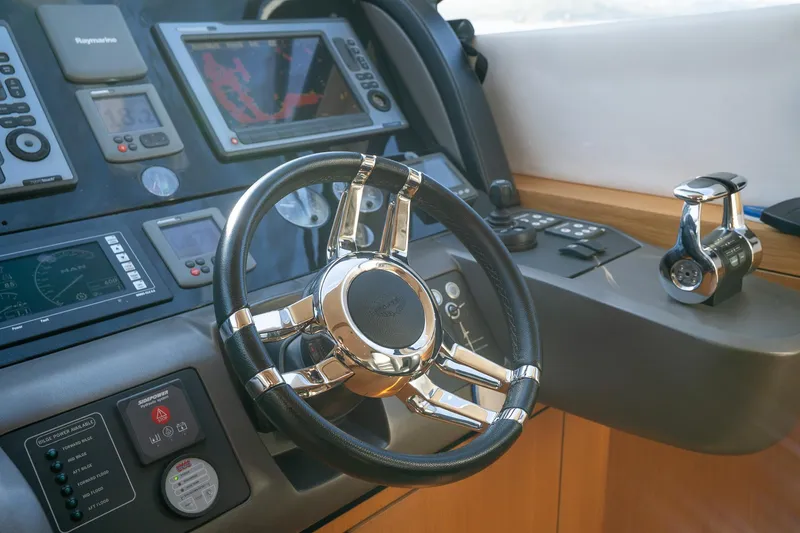 Just For Fun Yacht Photos Pics Steering wheel and controls of 2011 Sunseeker Manhattan 73 yacht cockpit.