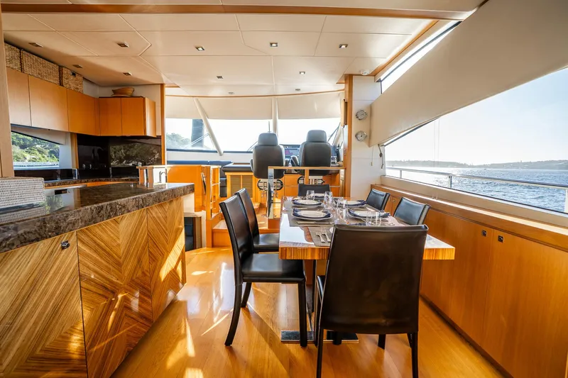 Just For Fun Yacht Photos Pics Luxurious interior of 2011 Sunseeker Manhattan 73 yacht with elegant dining area.