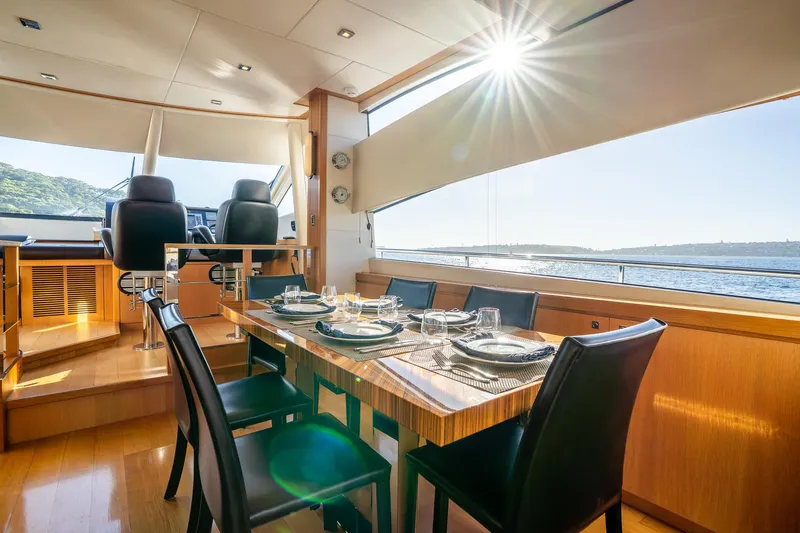 Just For Fun Yacht Photos Pics Luxurious interior of 2011 Sunseeker Manhattan 73 yacht with elegant dining setup.