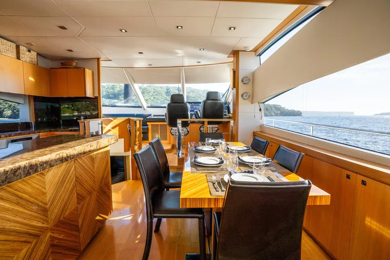 Just For Fun Yacht Photos Pics Luxurious interior of 2011 Sunseeker Manhattan 73 yacht with elegant dining area and scenic ocean view.