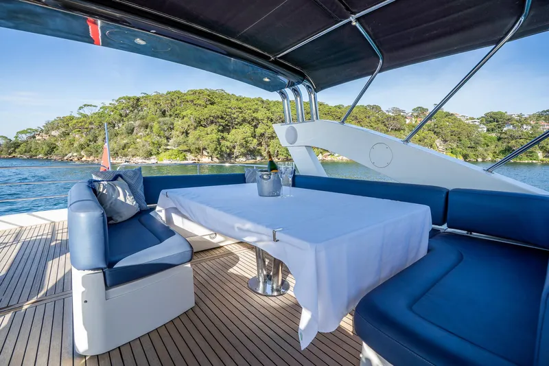 Just For Fun Yacht Photos Pics Luxury Sunseeker Manhattan 73 yacht deck with elegant seating, table, and scenic ocean view.