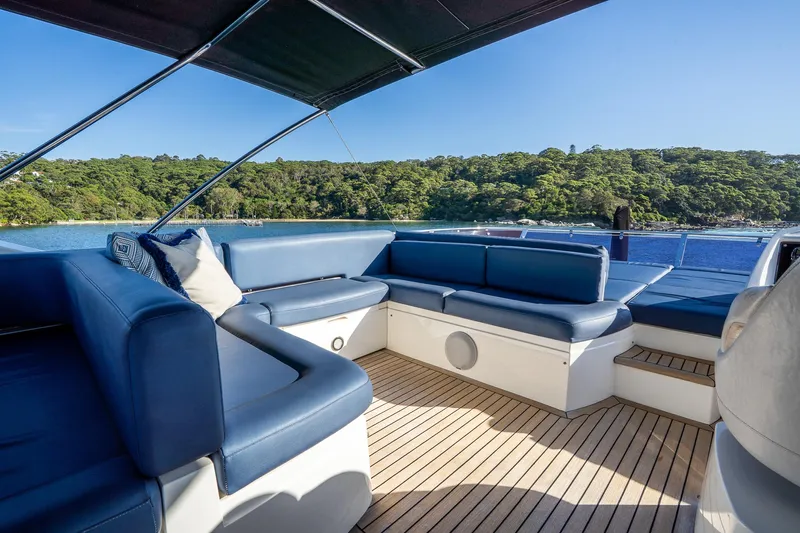 Just For Fun Yacht Photos Pics Luxurious Sunseeker Manhattan 73 yacht interior with blue seating, 2011 model, scenic ocean view.