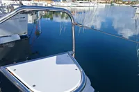 Leopard 45 catamaran docked in a serene marina, reflecting calm waters.