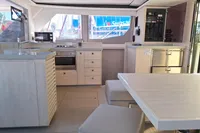 Modern kitchen interior of 2019 Leopard 45 yacht with light wood finish.