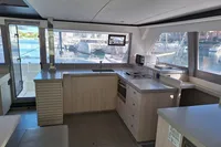 Modern kitchen interior of 2019 Leopard 45 catamaran with marina view.