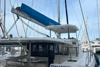 2019 Leopard 45 catamaran docked at marina, featuring spacious deck and blue sail cover.
