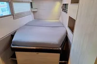 Cozy bedroom in 2019 Leopard 45 yacht with modern design and ample storage.